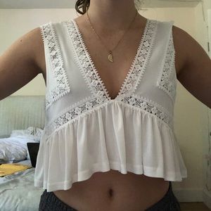 white flowy blouse with geometric pattern on front